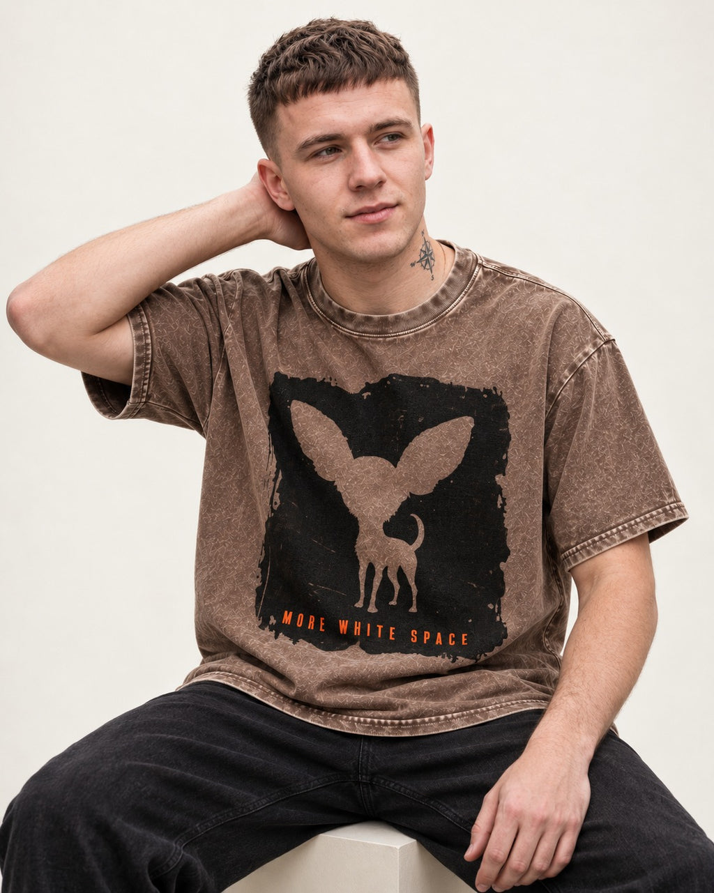 More White Space Chihuahua Washed Tee in Coffee, worn by a seated model