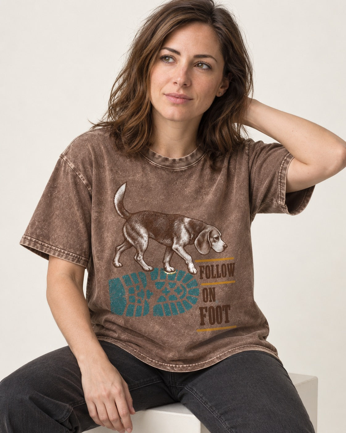 Follow the Beagle on Foot Washed Tee in Coffee, worn by a seated model