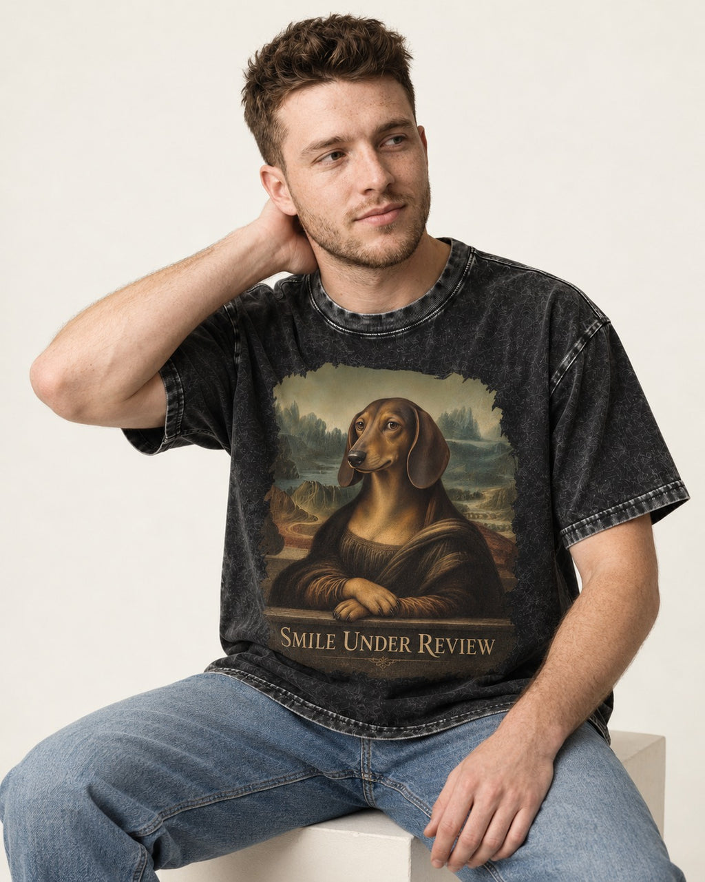 Dachshund Smile Under Review Mona Lisa Graphic Washed Tee in Black, worn by a seated model