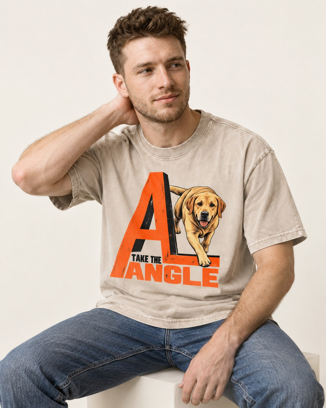 Take the Angle Labrador Retriever Washed Tee in Apricot, worn by a seated model