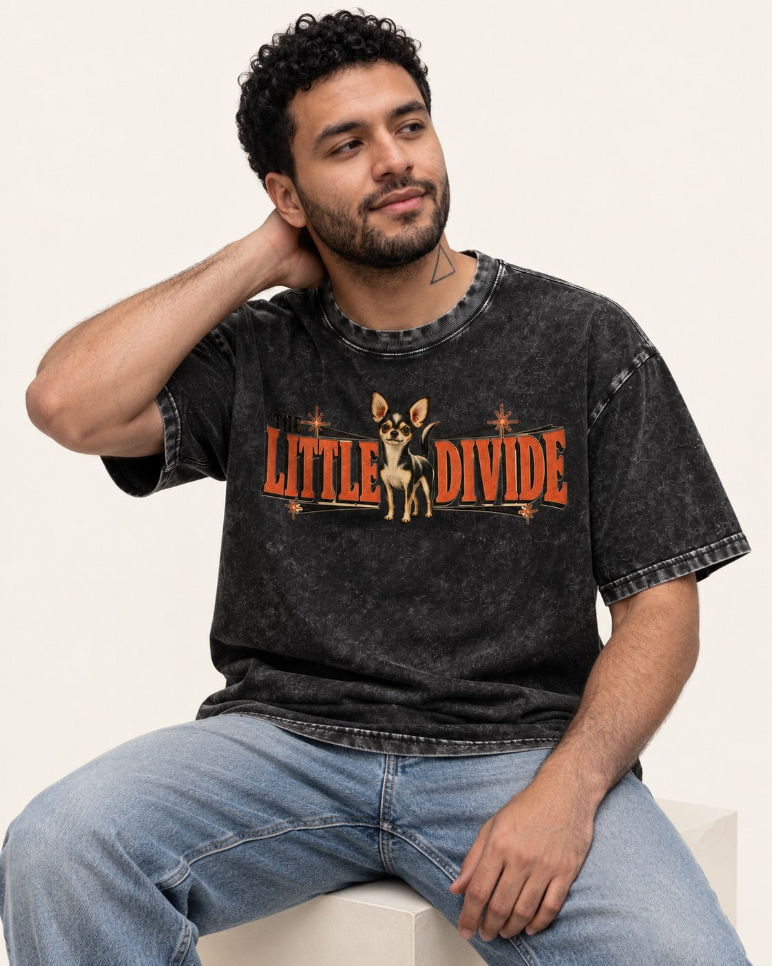 Chihuahua The Little Divide Retro Sign Graphic Washed Tee in Black, worn by a seated model