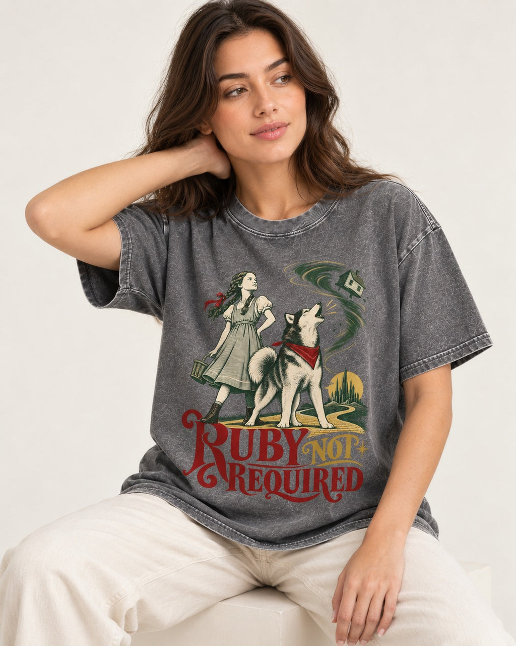 Ruby Not Required for Husky Washed Tee in Gray, worn by a seated model