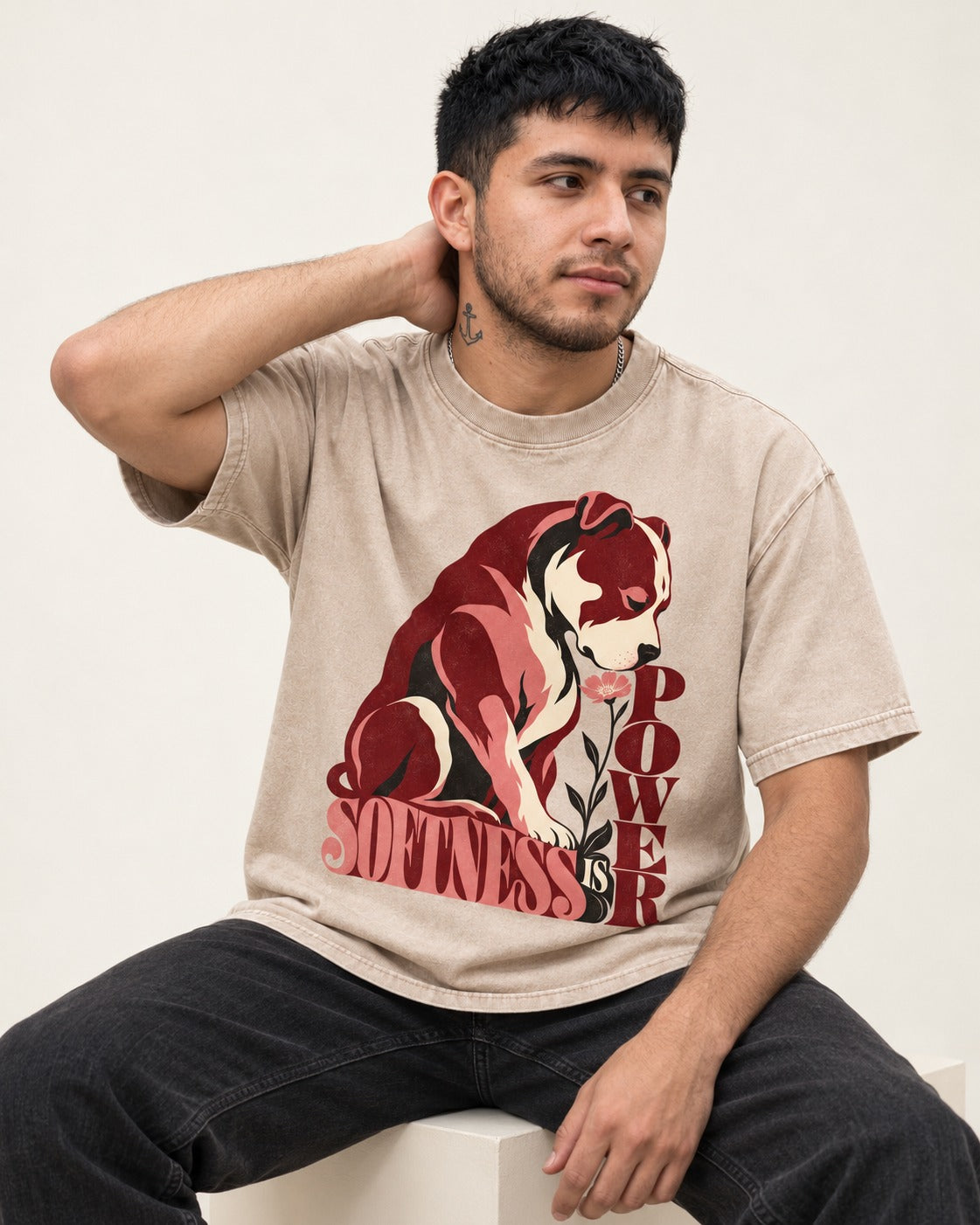 Pitbull Softness Is Power Flower Graphic Washed Tee in Apricot, worn by a seated model