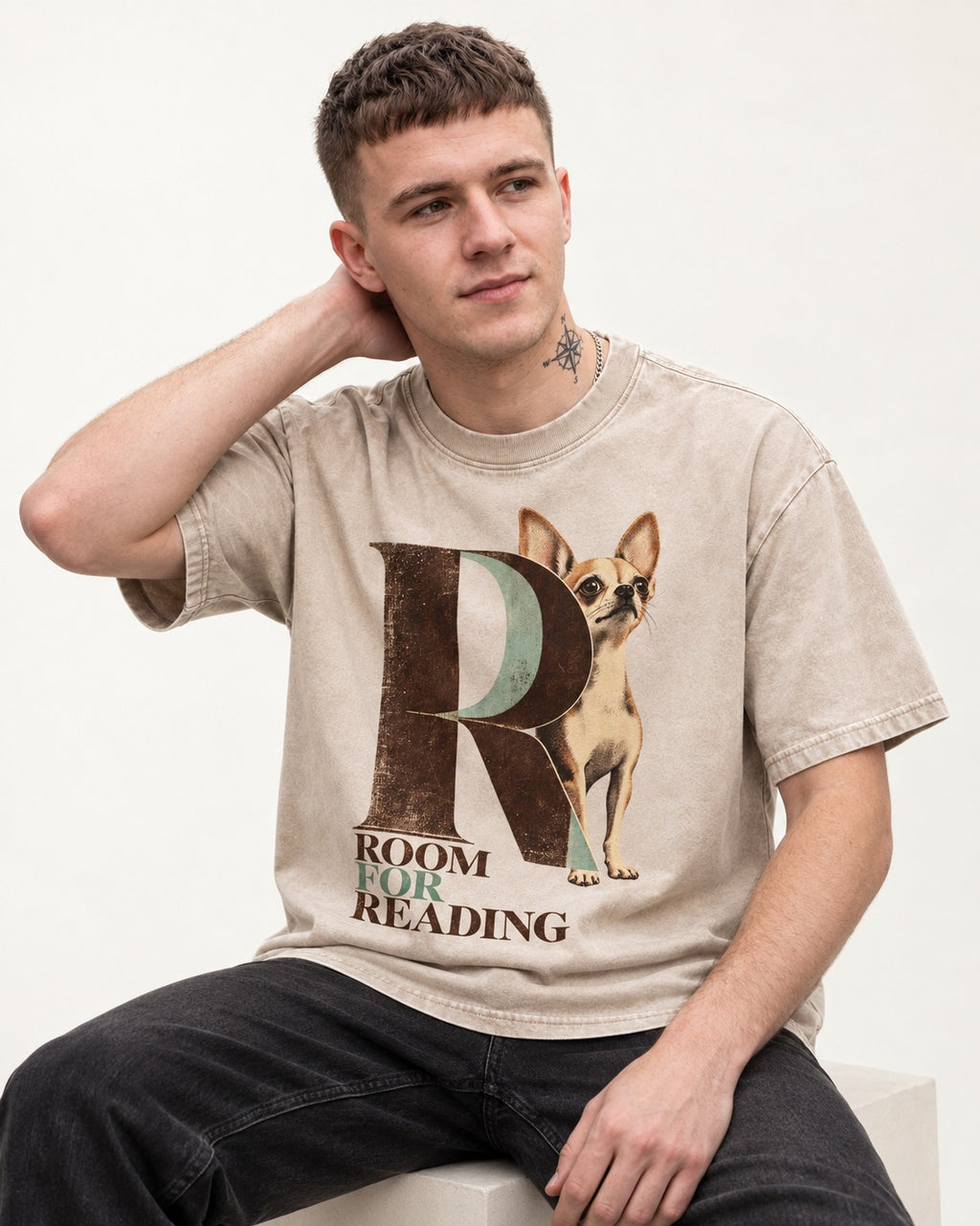 Chihuahua Room for Reading Editorial Monogram Washed Tee in Apricot, worn by a seated model