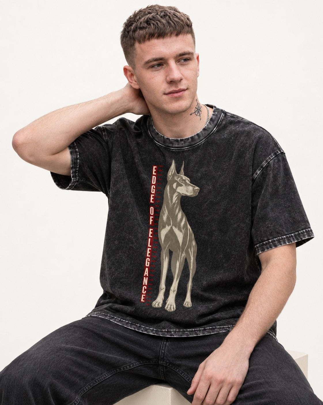 Doberman Edge of Elegance Height Chart Graphic Washed Tee in Black, worn by a seated model