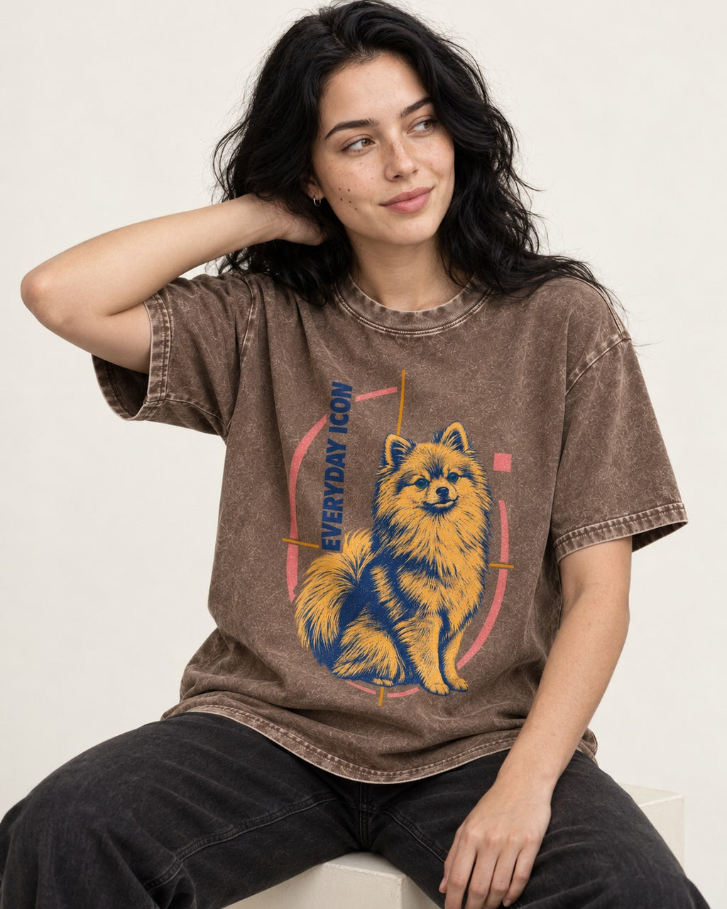 Pomeranian Everyday Icon Washed Tee in Coffee, worn by a seated model