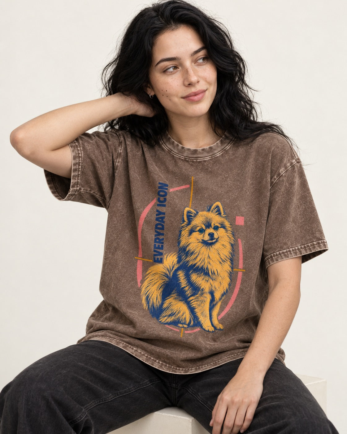 Pomeranian Everyday Icon Washed Tee in Coffee, worn by a seated model