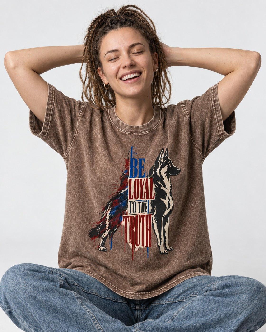 Loyal to the Truth German Shepherd Dog Washed Tee in Coffee, worn by a seated model