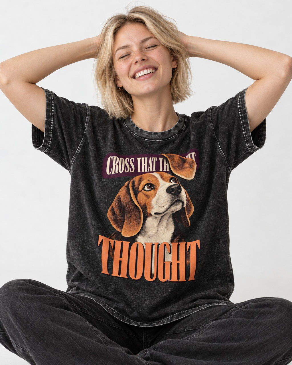 Cross That Beagle Thought Washed Tee in Black, worn by a seated model