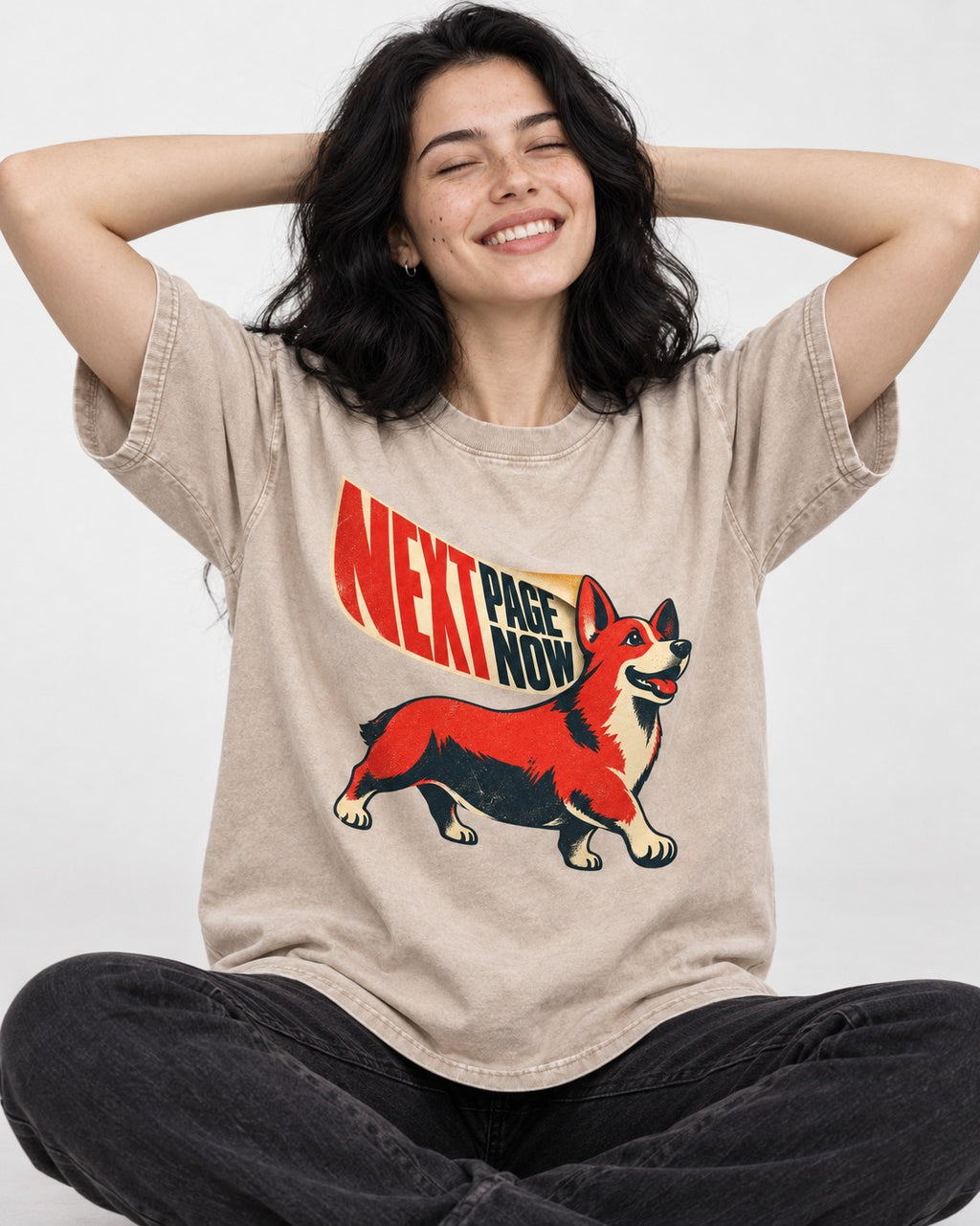 Corgi Next Page Now Pennant Graphic Washed Tee in Apricot, worn by a seated model