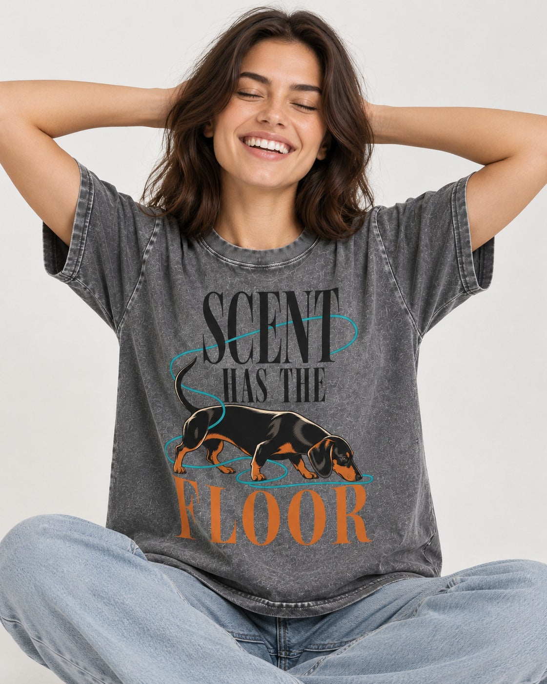 Dachshund Scent Has the Floor Washed Tee in Gray, worn by a seated model