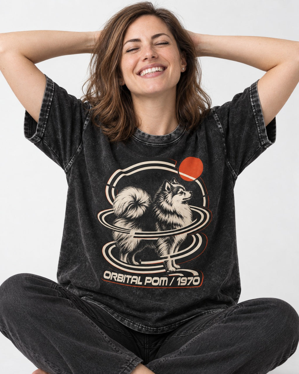 Pomeranian Orbital Pom 1970 Space Age Graphic Washed Tee in Black, worn by a seated model