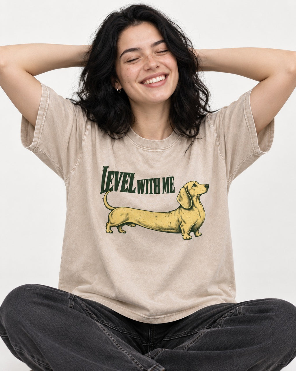 Dachshund Level with Me Washed Tee in Apricot, worn by a seated model
