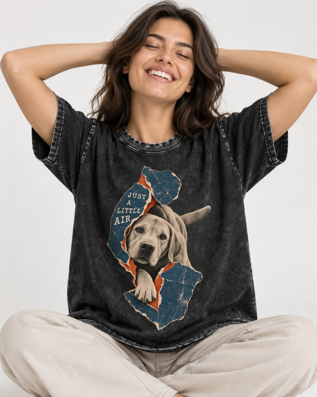 Labrador Retriever Just a Little Air Torn Paper Graphic Washed Tee in Black, worn by a seated model