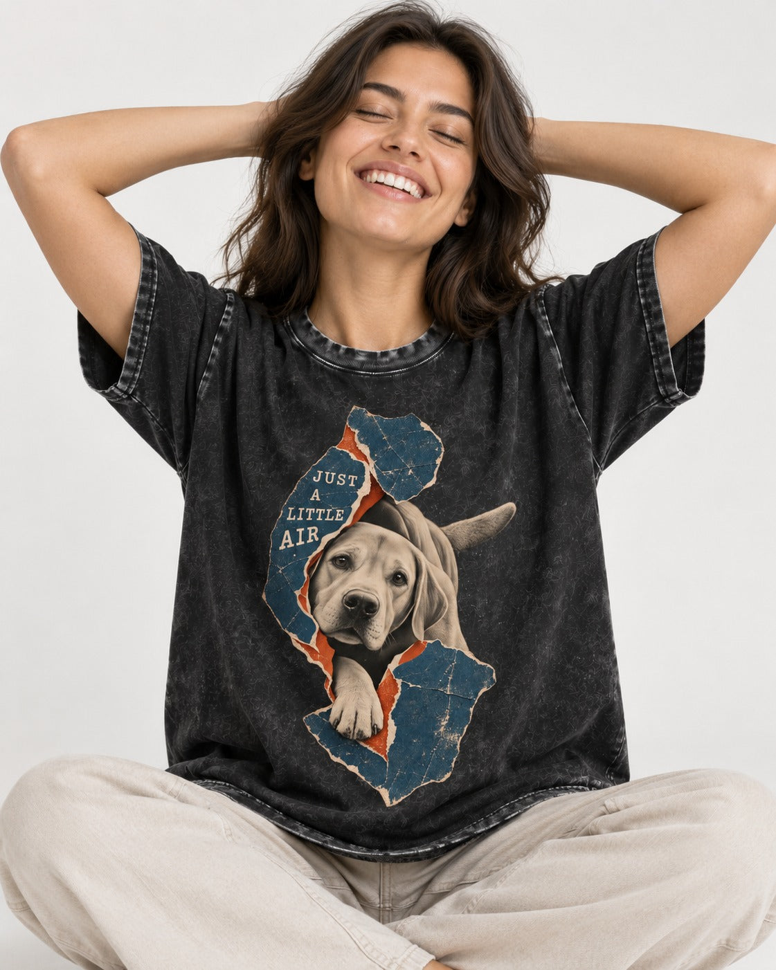 Labrador Retriever Just a Little Air Torn Paper Graphic Washed Tee in Black, worn by a seated model