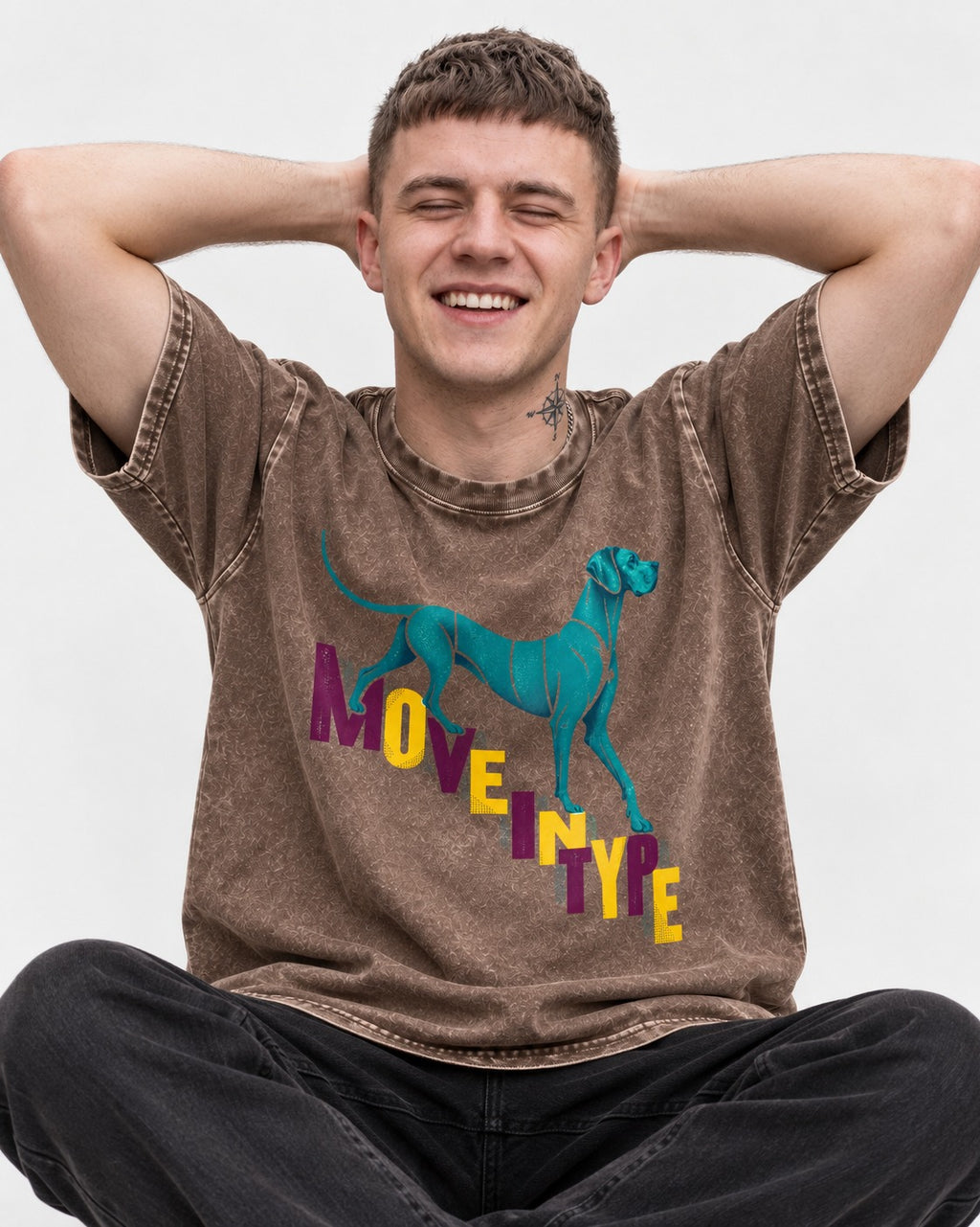 Great Dane Move in Type Washed Tee in Coffee, worn by a seated model