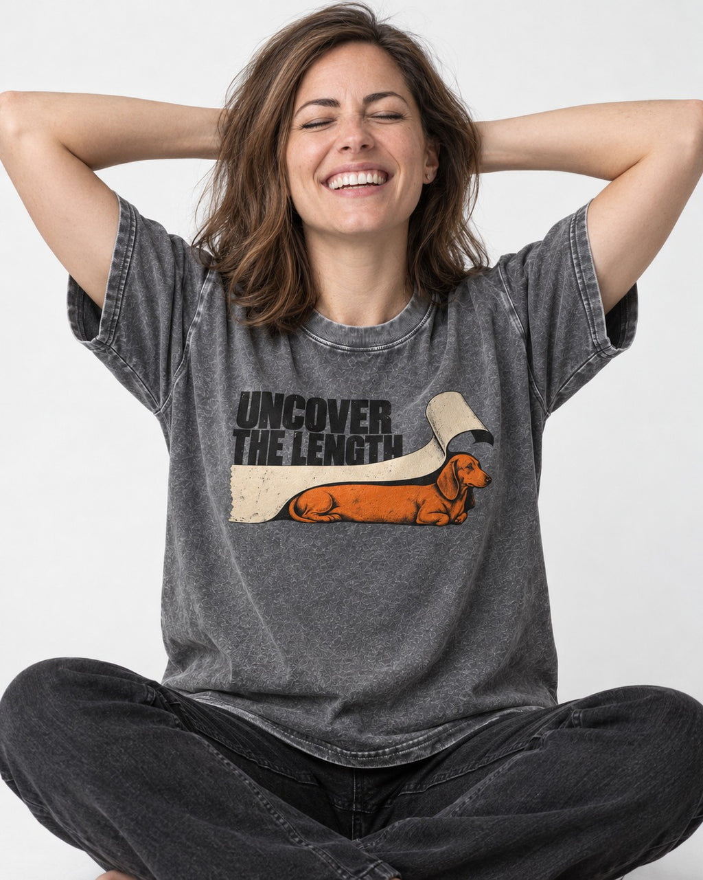 Uncover the Dachshund Length Washed Tee in Gray, worn by a seated model