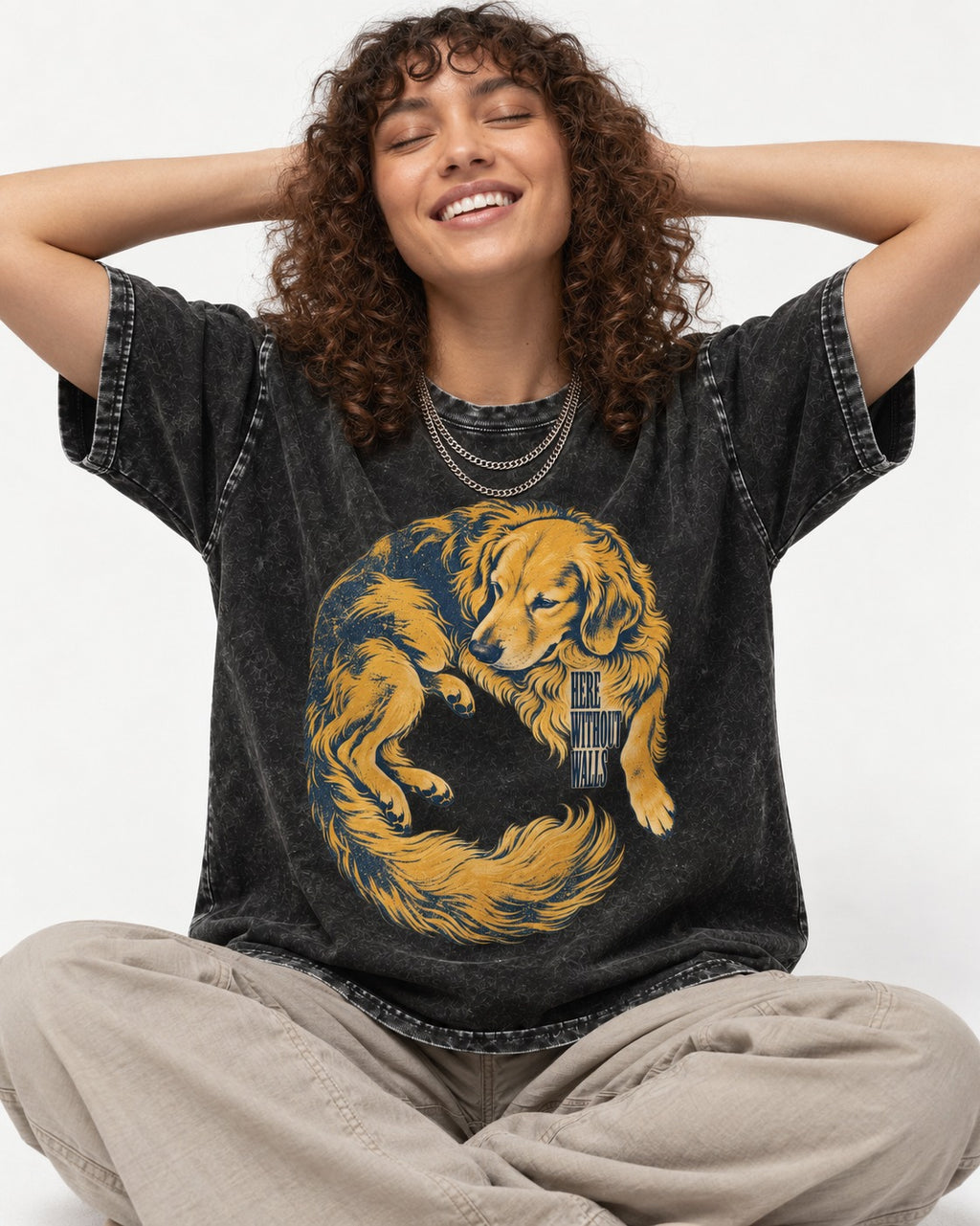Golden Retriever Here Without Walls Curled Portrait Graphic Washed Tee in Black, worn by a seated model
