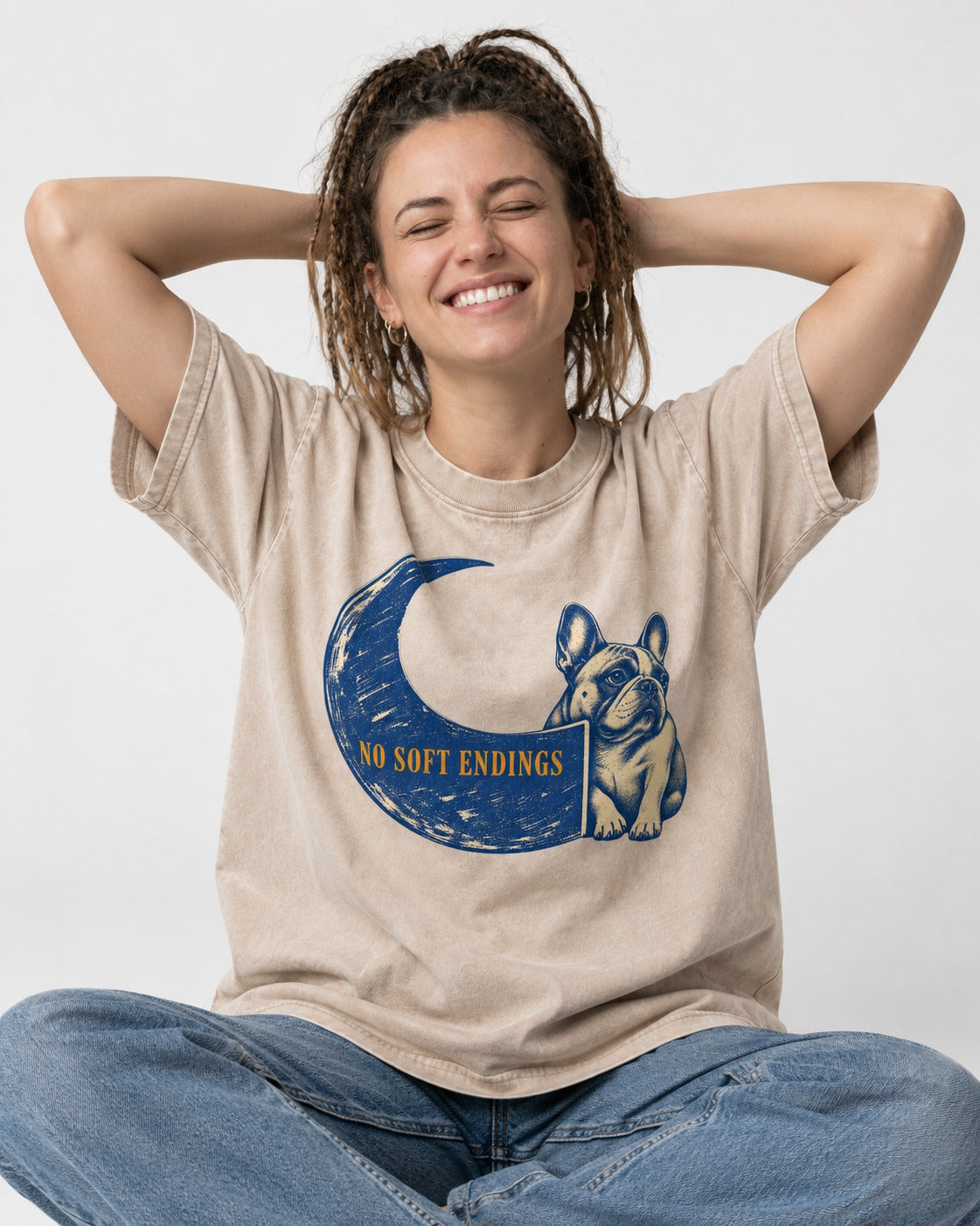 Frenchie No Soft Endings Crescent Graphic Washed Tee in Apricot, worn by a seated model