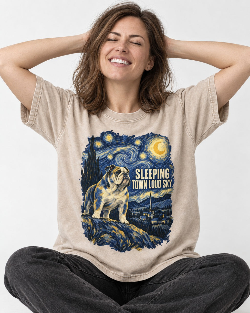 English Bulldog Sleeping Town Loud Sky Starry Night Graphic Washed Tee in Apricot, worn by a seated model