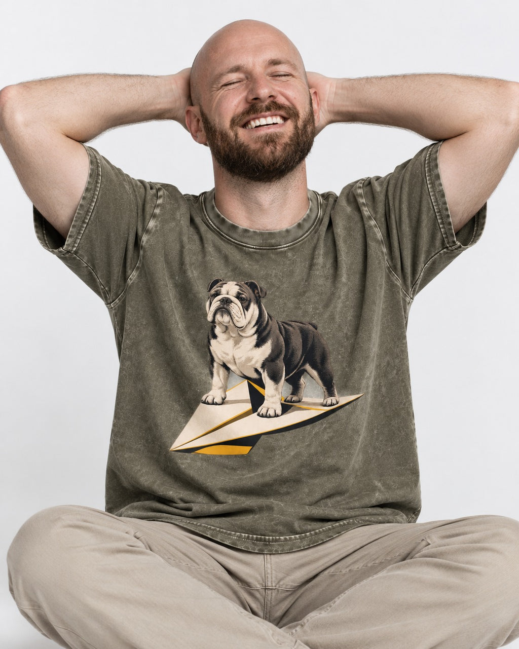 English Bulldog Paper Airplane Graphic Washed Tee in Army Green, worn by a seated model