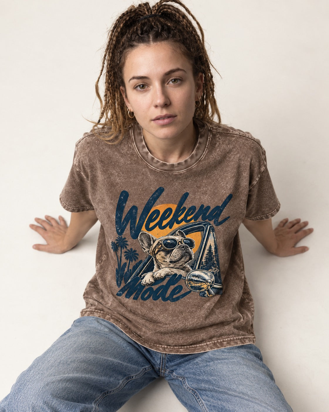 Frenchie Weekend Mode Road Trip Graphic Washed Tee in Coffee, worn by a seated model
