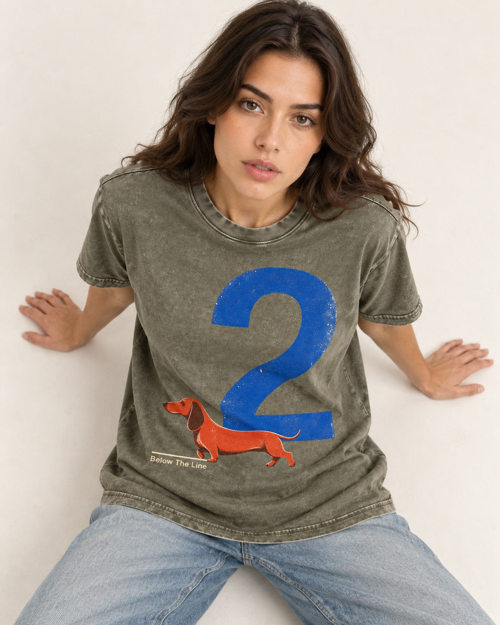 Dachshund Below The Line Number Two Graphic Washed Tee in Army Green, worn by a seated model