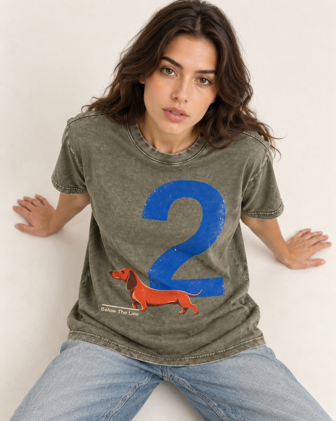 Dachshund Below The Line Number Two Graphic Washed Tee in Army Green, worn by a seated model