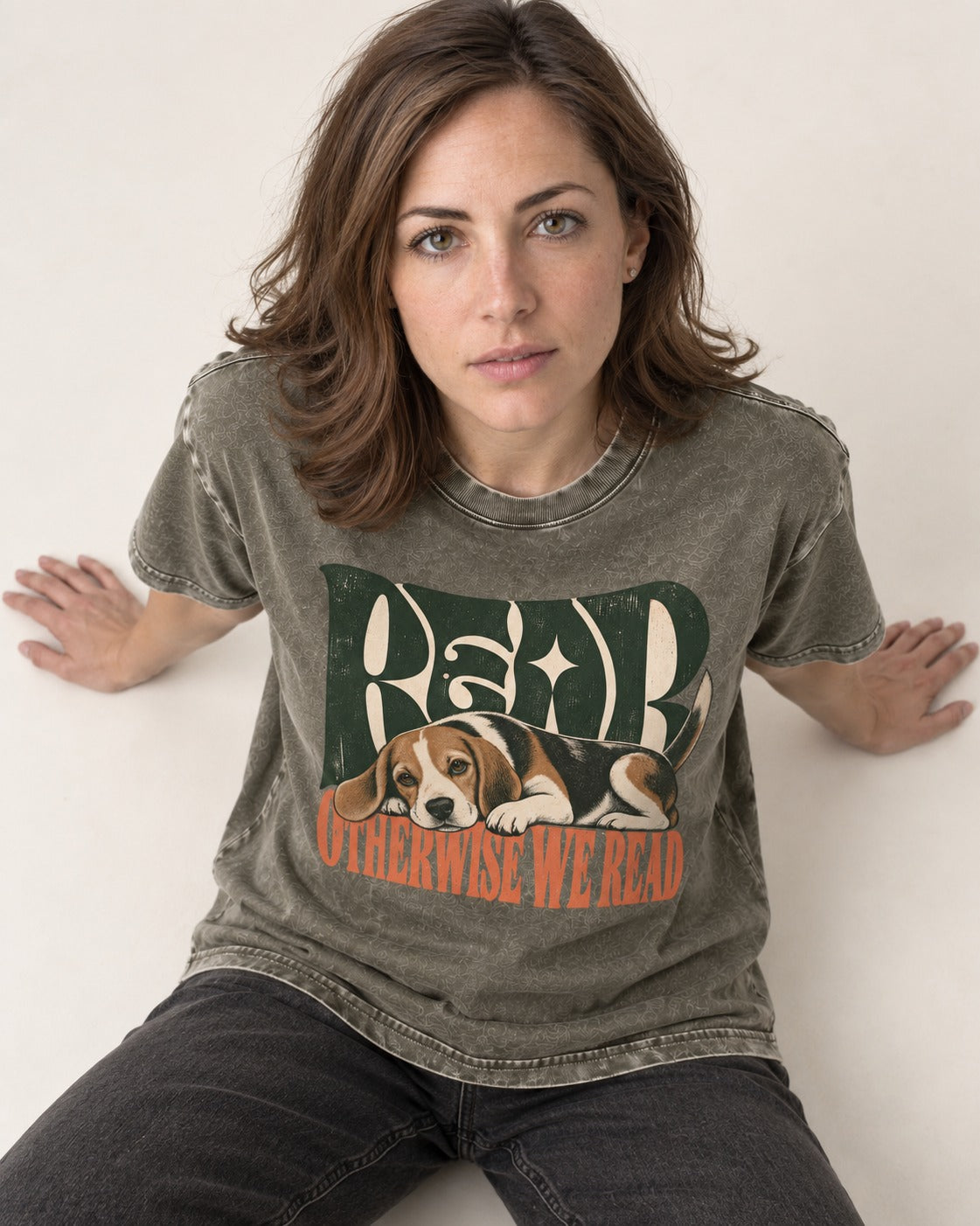 Beagle Read Otherwise We Read Retro Graphic Washed Tee in Army Green, worn by a seated model
