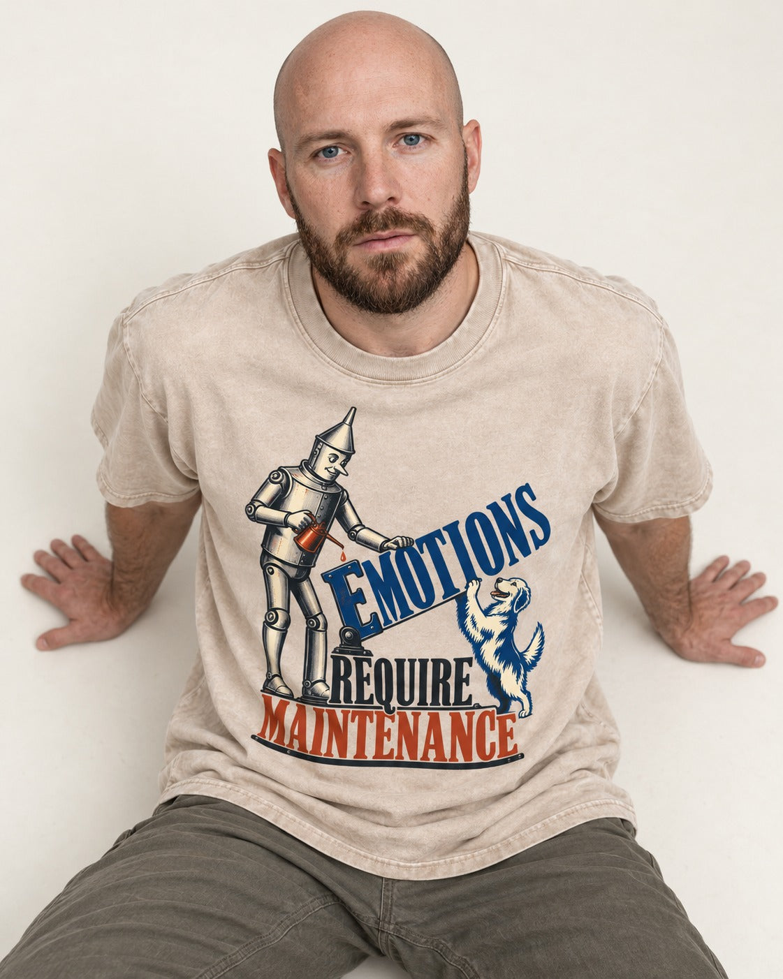 Golden Retriever Emotions Require Maintenance Washed Tee in Apricot, worn by a seated model