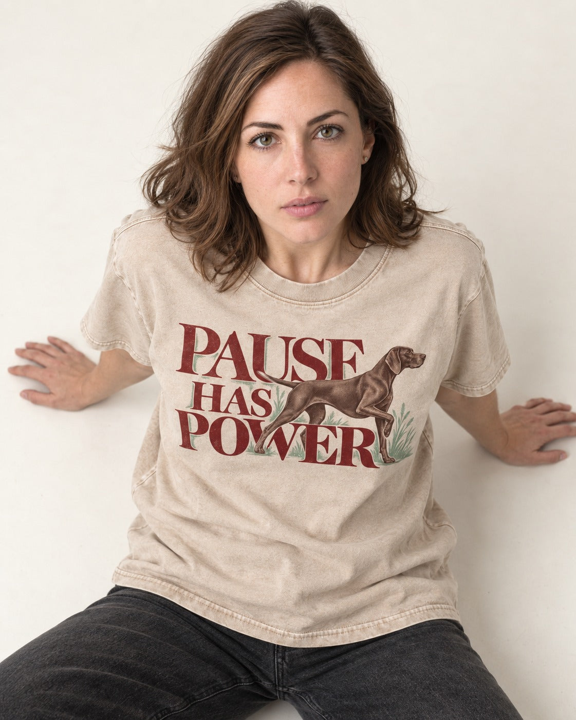 Pause Has Power German Shorthaired Pointer Washed Tee in Apricot, worn by a seated model