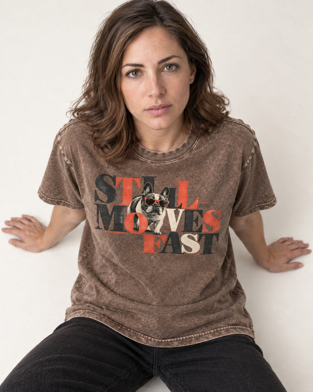 Frenchie Still Moves Fast Washed Tee in Coffee, worn by a seated model