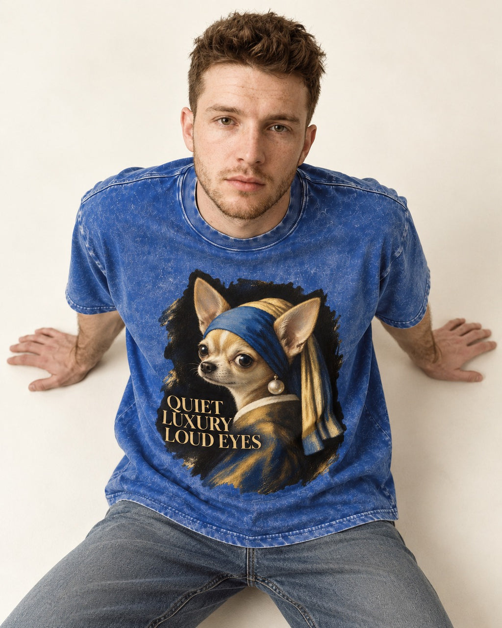 Chihuahua Quiet Luxury Loud Eyes Pearl Earring Portrait Washed Tee in Royal Blue, worn by a seated model