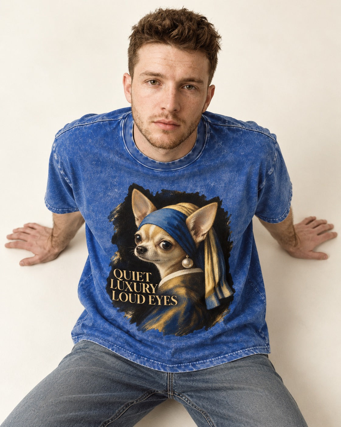 Chihuahua Quiet Luxury Loud Eyes Pearl Earring Portrait Washed Tee in Royal Blue, worn by a seated model