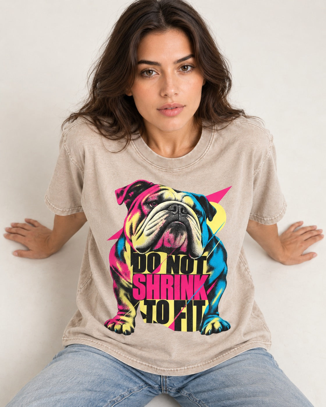 English Bulldog Don't Shrink to Fit Washed Tee in Apricot, worn by a seated model