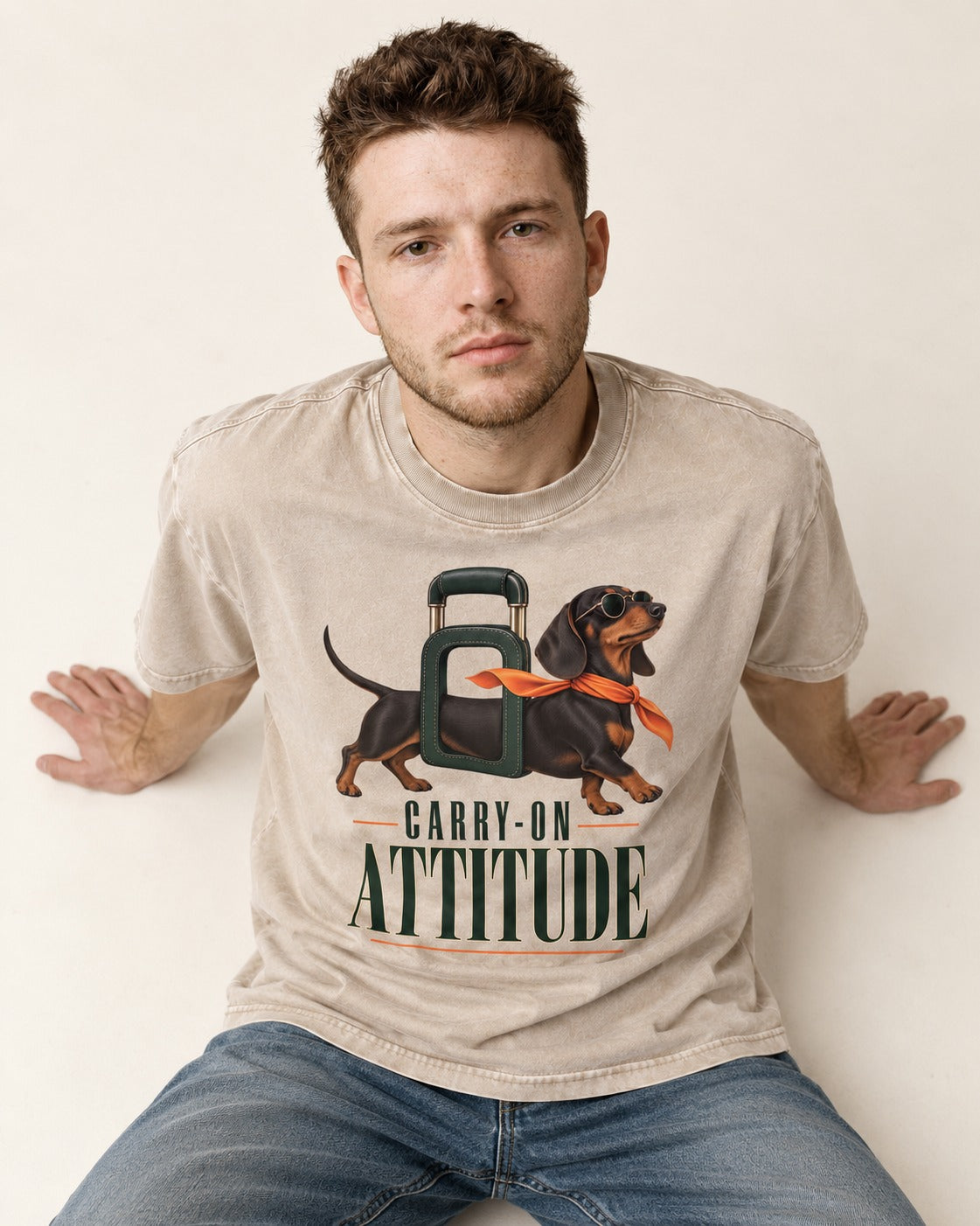 Dachshund Carry on Attitude Washed Tee in Apricot, worn by a seated model