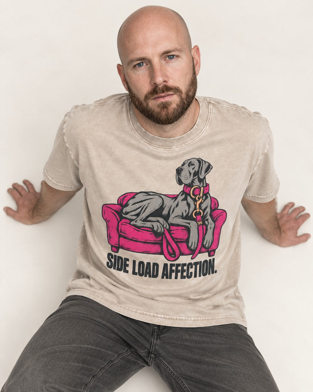 Great Dane Side Load Affection Washed Tee in Apricot, worn by a seated model