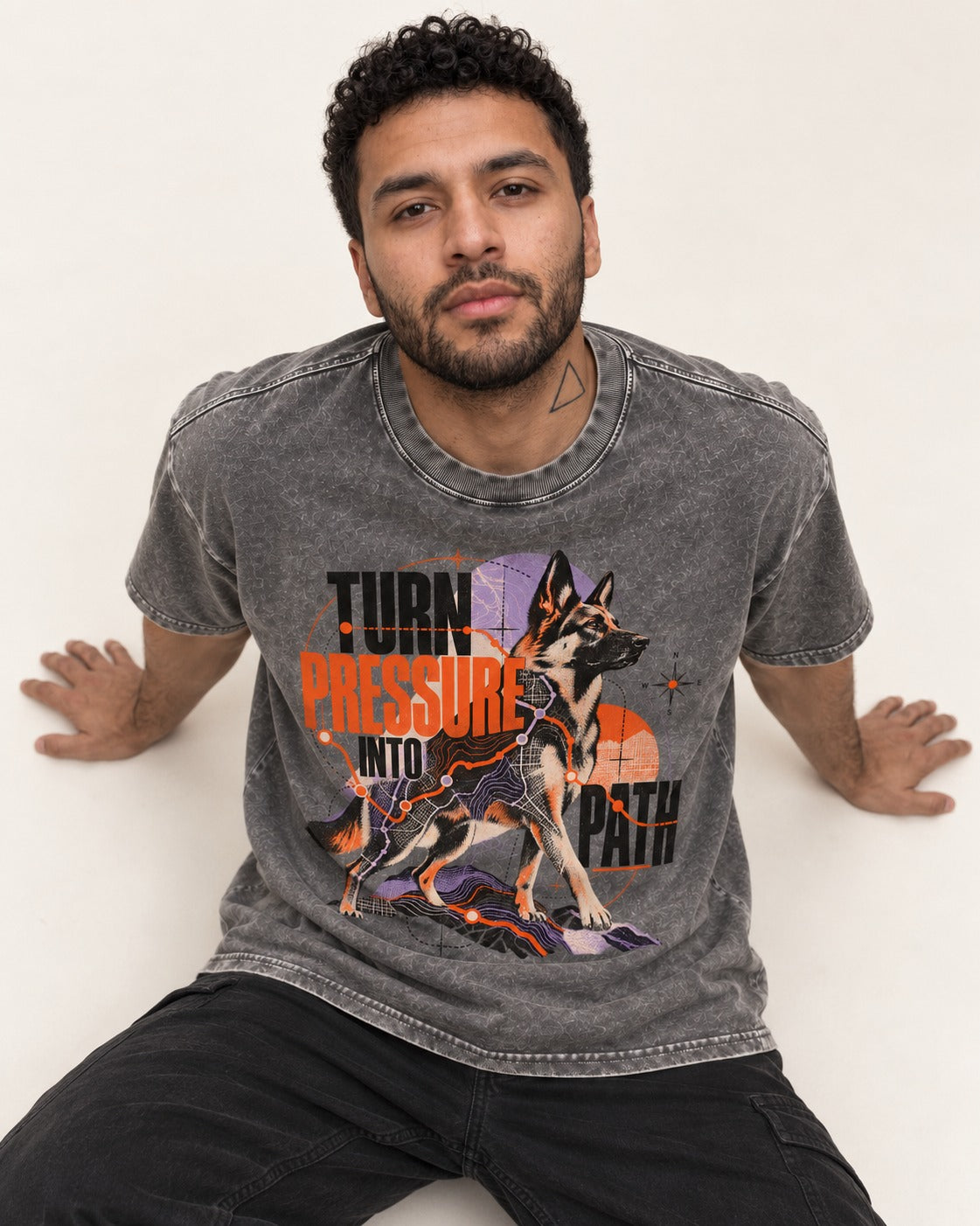 Turn Pressure Into Path German Shepherd Dog Washed Tee in Gray, worn by a seated model