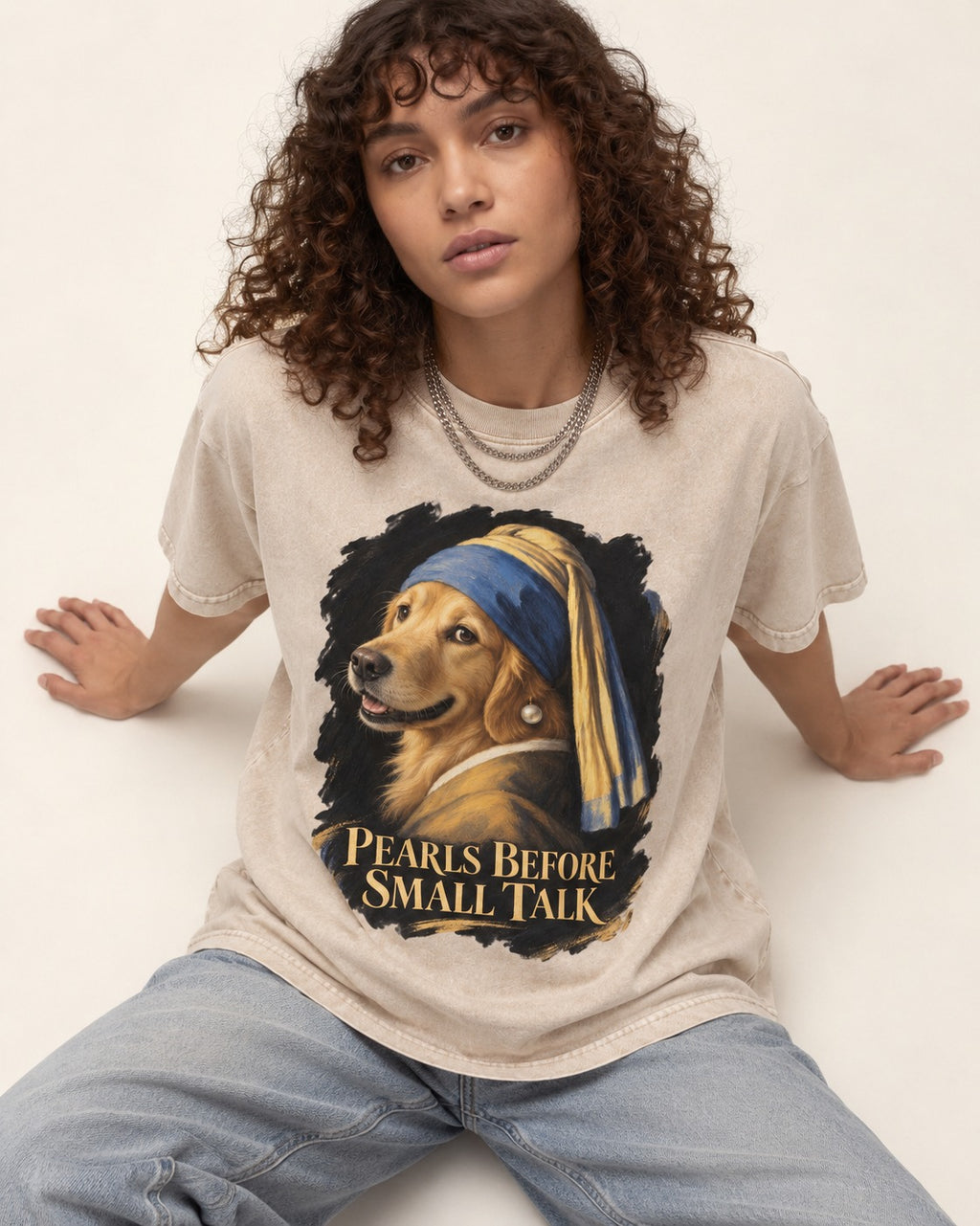 Pearls Before Small Talk Pearl Portrait Golden Retriever Graphic Washed Tee in Apricot, worn by a seated model