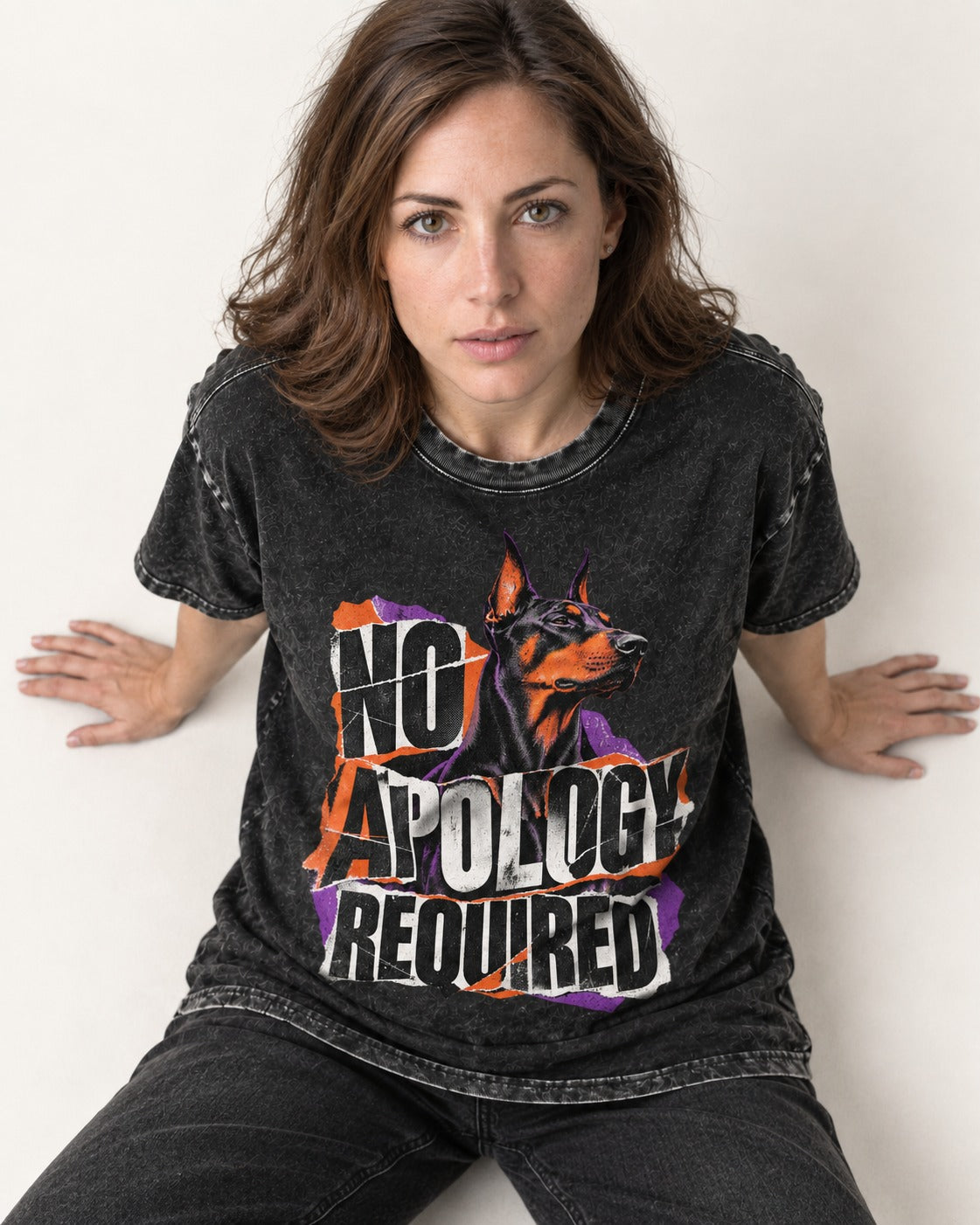 Doberman No Apology Required Torn Paper Graphic Washed Tee in Black, worn by a seated model