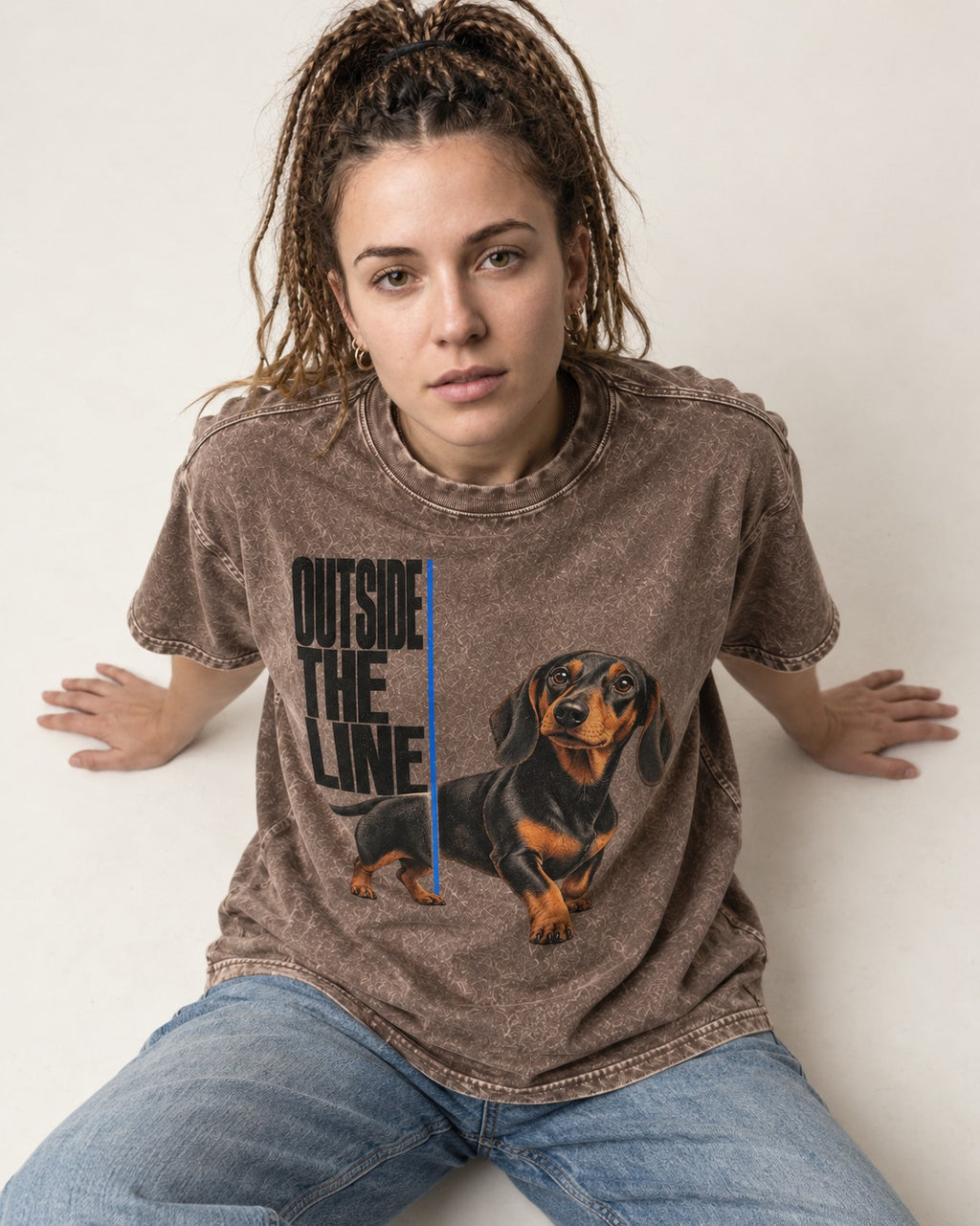 Dachshund Outside the Line Washed Tee in Coffee, worn by a seated model
