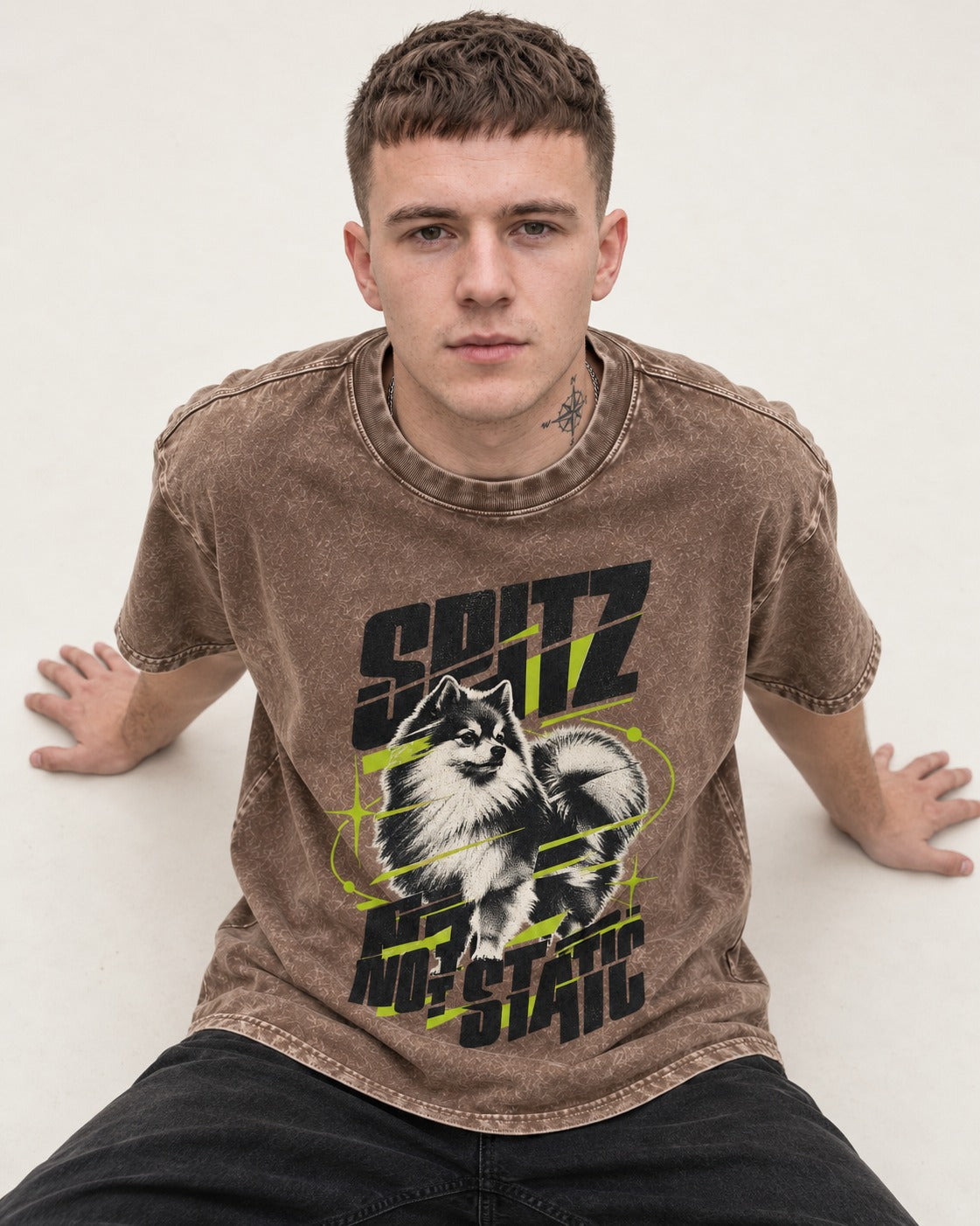 Pomeranian Not Static Washed Tee in Coffee, worn by a seated model