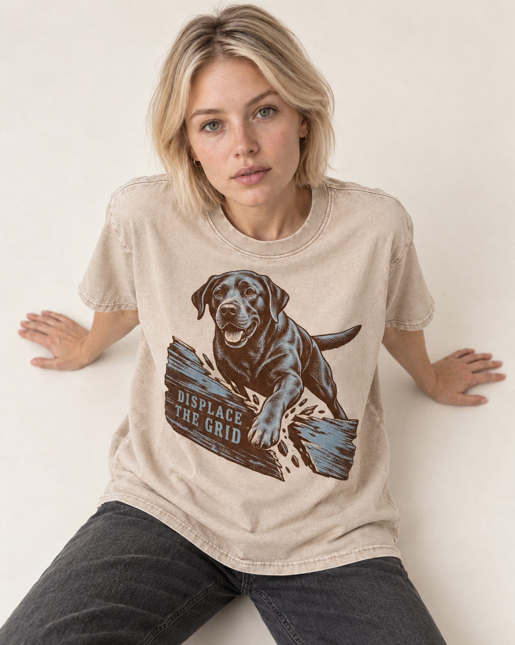 Labrador Retriever Displace the Grid Breaking Plank Graphic Washed Tee in Apricot, worn by a seated model