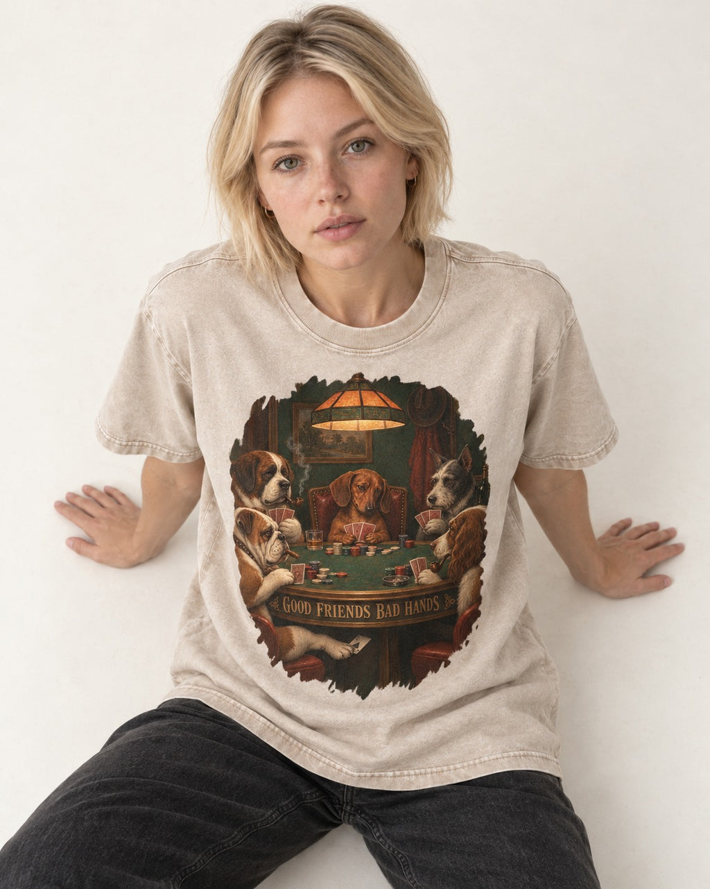 Dachshund Good Friends Bad Hands Poker Scene Washed Tee in Apricot, worn by a seated model