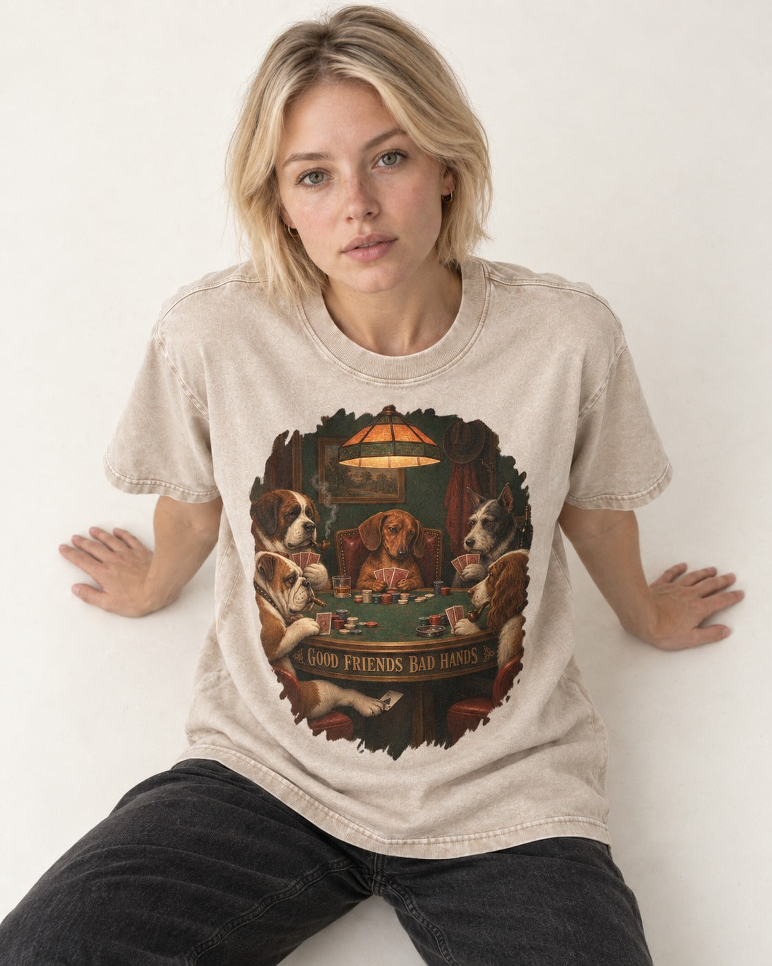 Dachshund Good Friends Bad Hands Poker Scene Washed Tee in Apricot, worn by a seated model