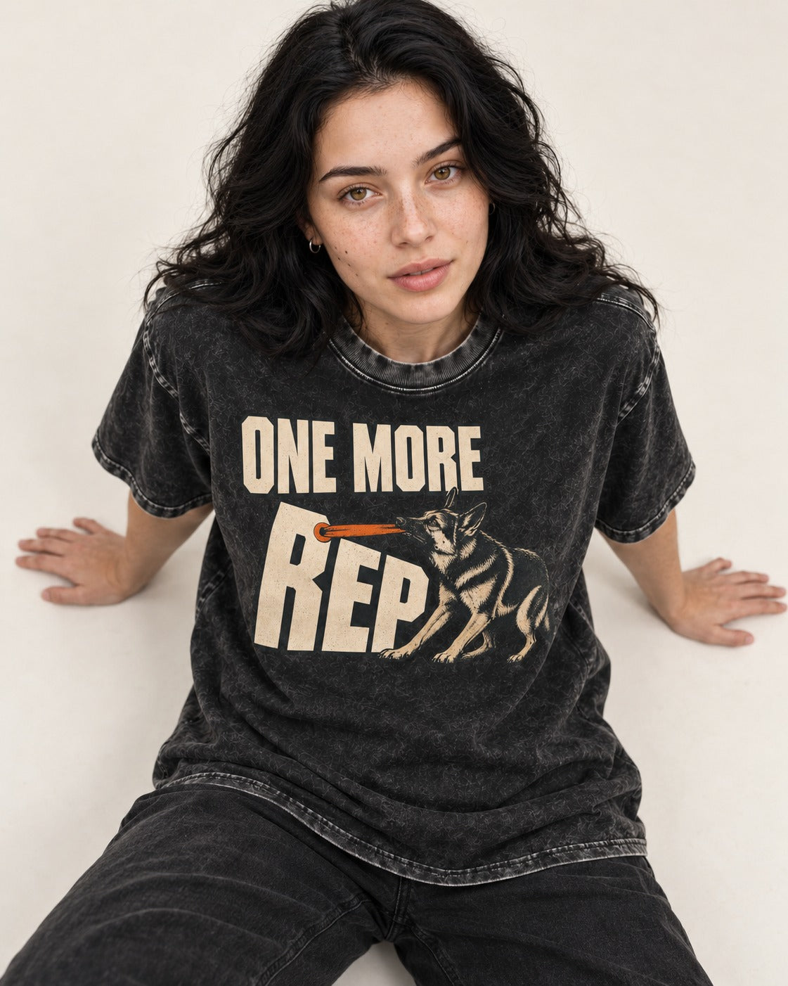 One More Rep Tug German Shepherd Dog Graphic Washed Tee in Black, worn by a seated model