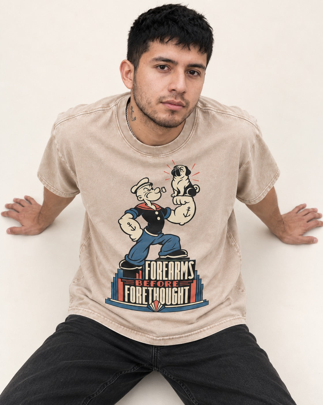Pug Forearms Before Forethought Washed Tee in Apricot, worn by a seated model