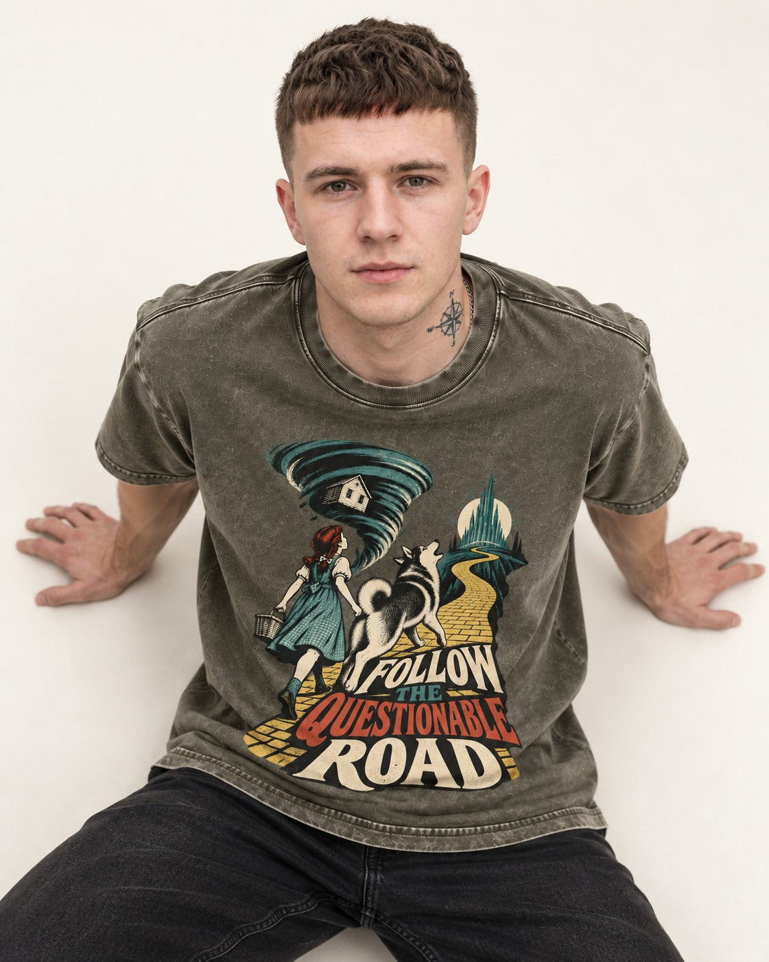 Husky Follow the Questionable Road Tornado Graphic Washed Tee in Army Green, worn by a seated model