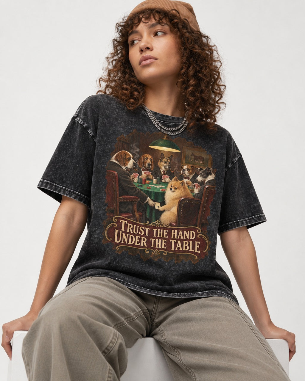 Pomeranian Trust the Hand Under the Table Poker Dogs Graphic Washed Tee in Black, worn by a seated model