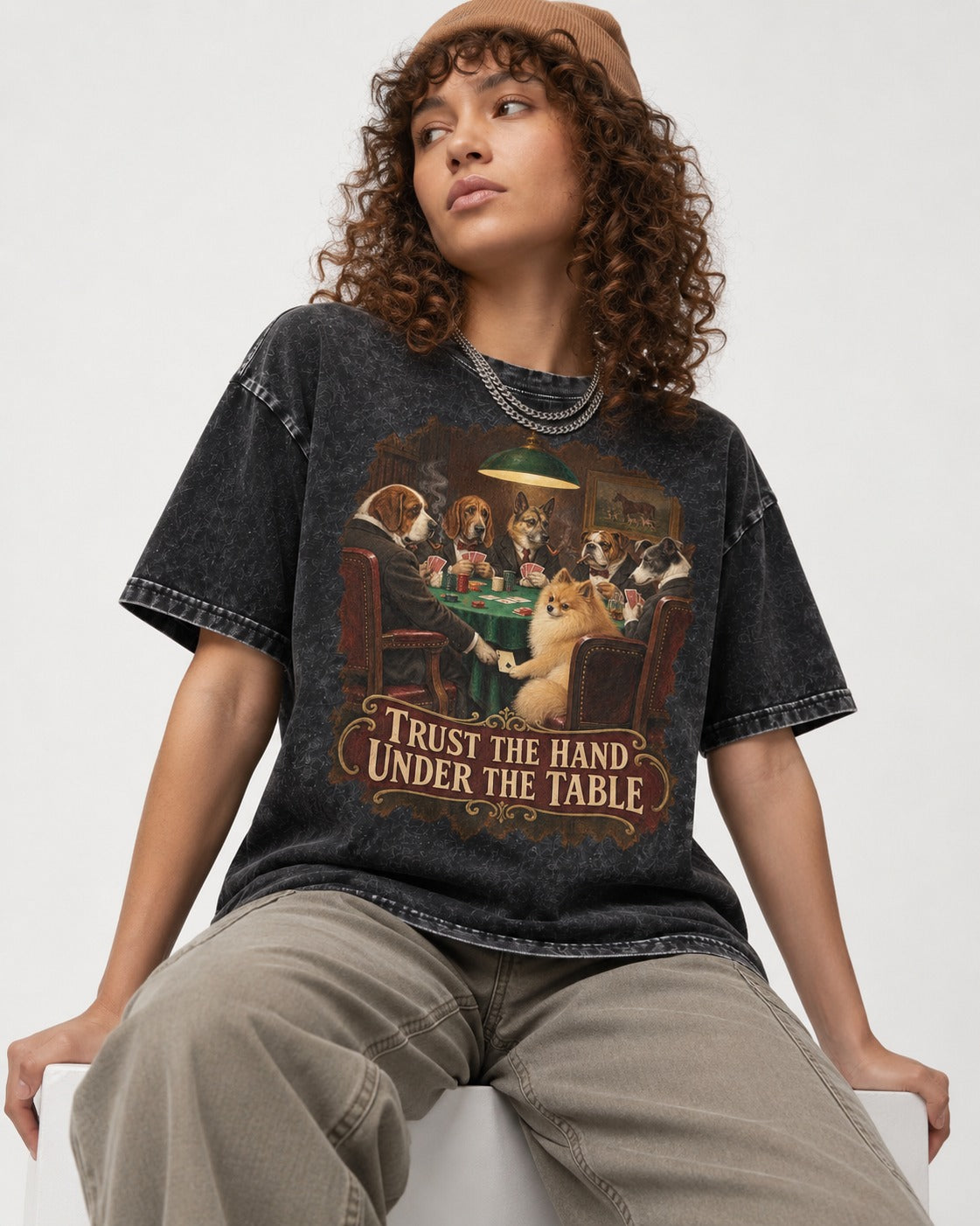 Pomeranian Trust the Hand Under the Table Poker Dogs Graphic Washed Tee in Black, worn by a seated model